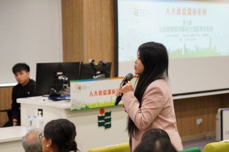 A student engages in a lively discussion with the speakers