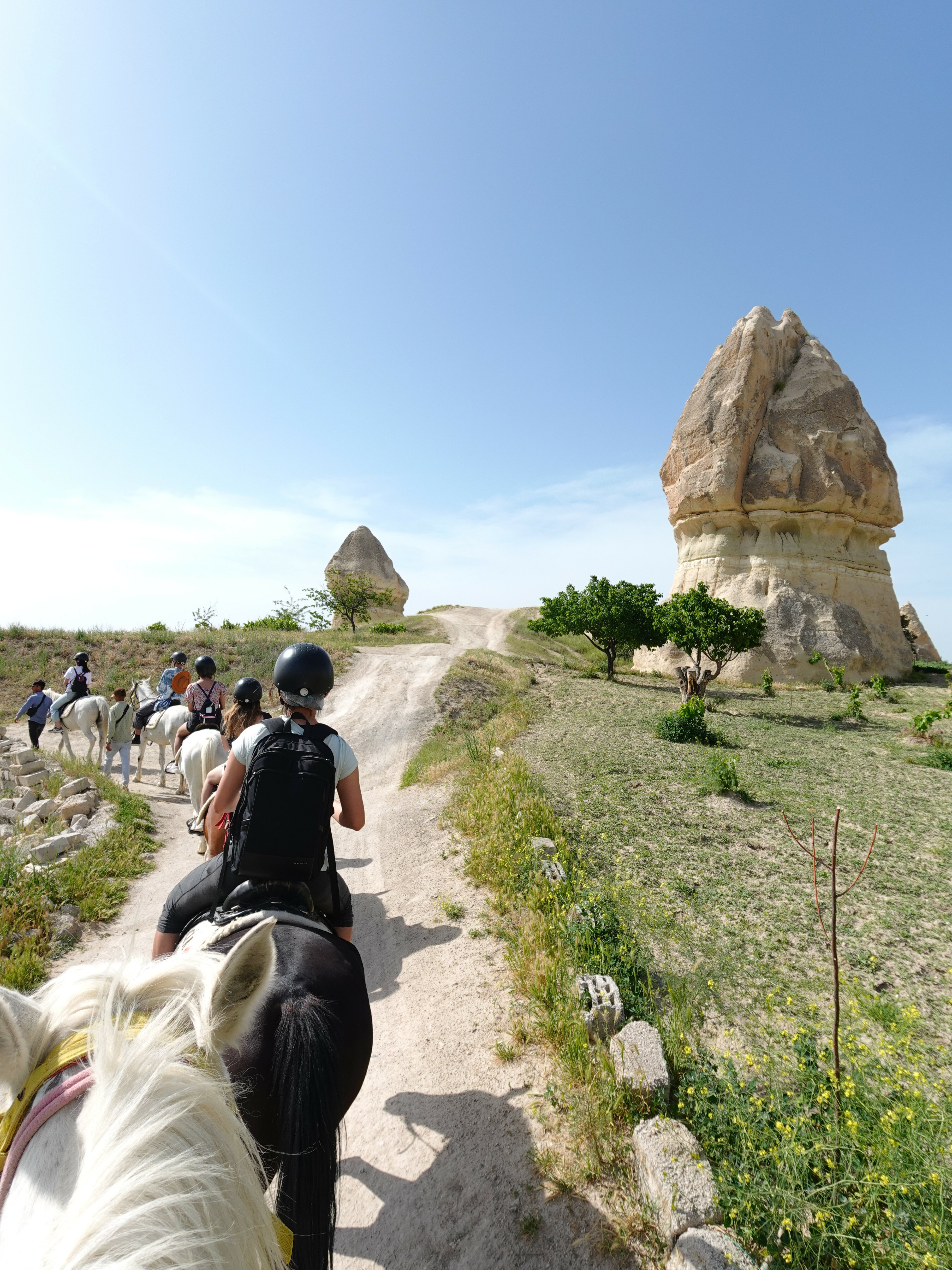 They explore the mountainous terrain and caves of Cappadocia on horseback